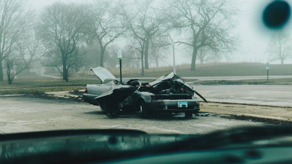 Detailed view of shattered car windshield after accident, emphasizing damage and broken glass.