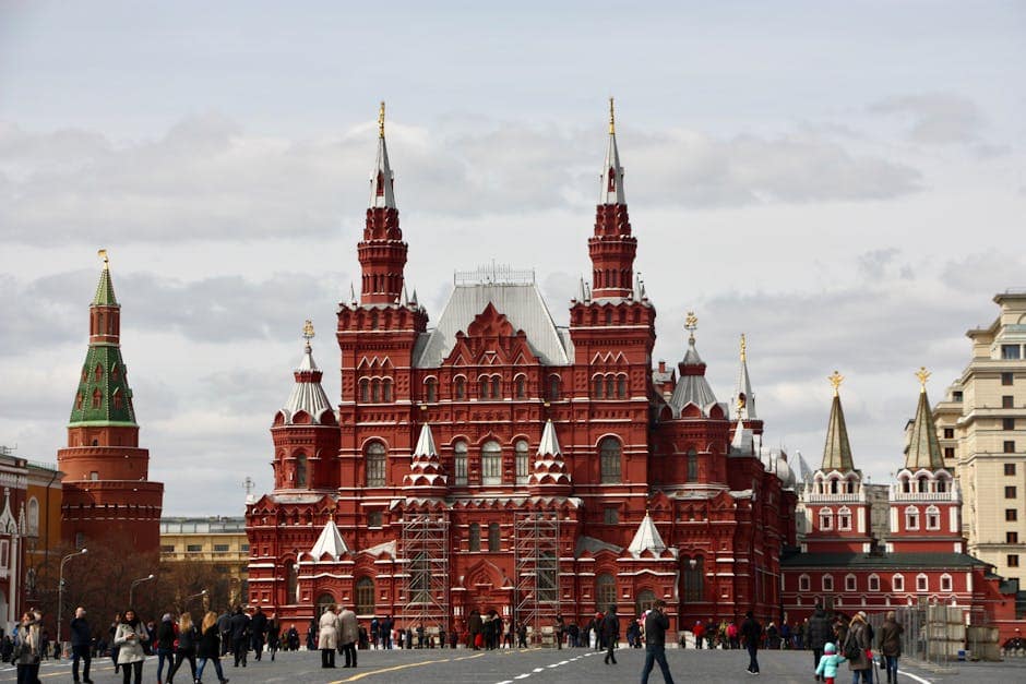 Vibrant view of Saint Basil's Cathedral against a cloudy sky in Moscow's Red Square.