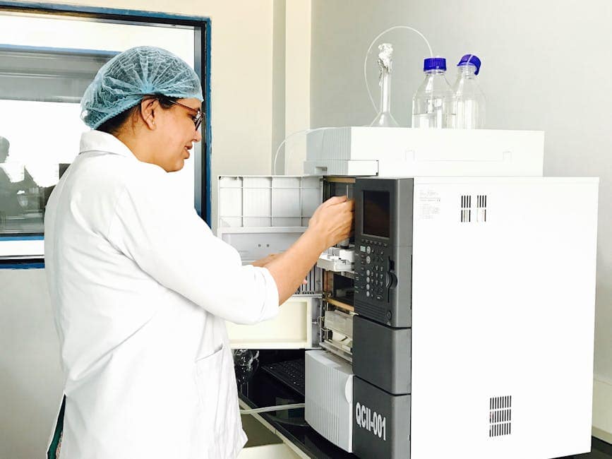 Vibrant laboratory setup with glassware, colored liquids, and a microscope for scientific research.