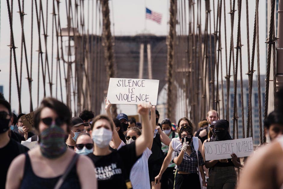 Top view of slogan silence allows violence on carton placed on rough asphalt road on street