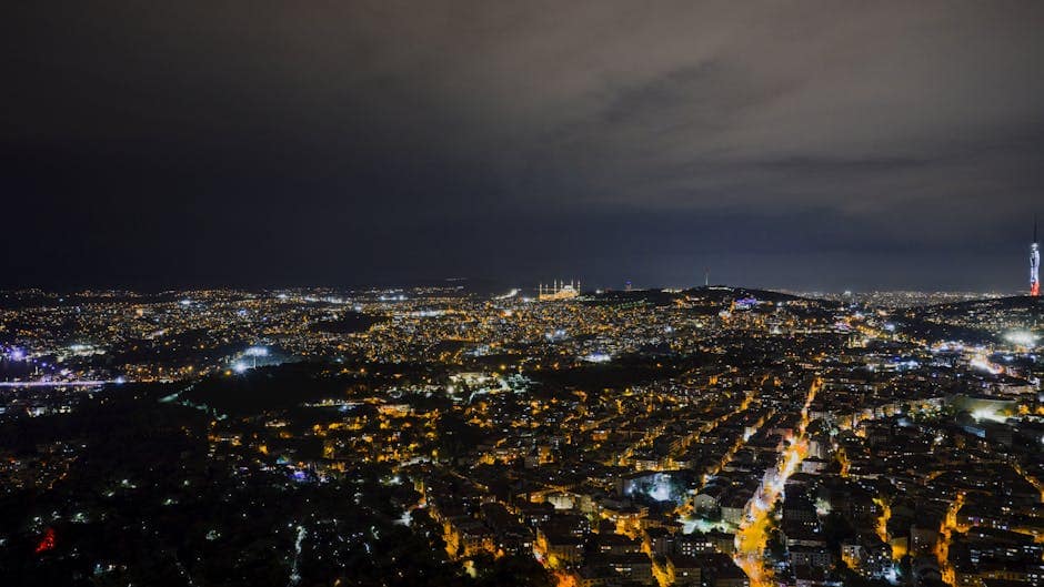 A captivating night aerial view of Istanbul's illuminated skyline with iconic landmarks visible.