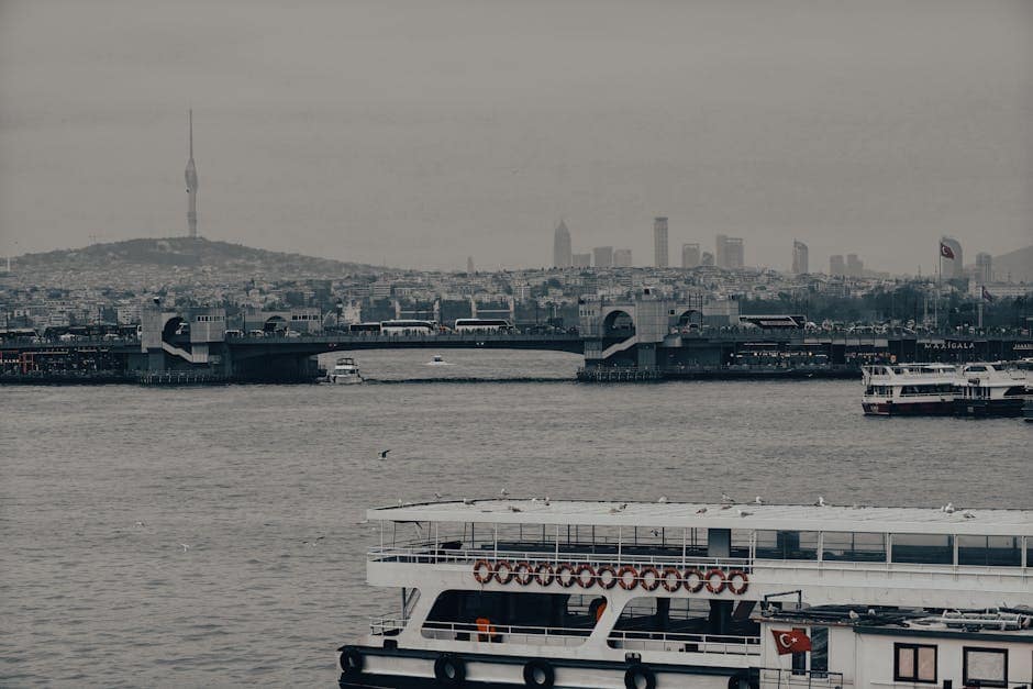 Bosphorus view from Istanbul with Galata Bridge and city skyline on a cloudy day.