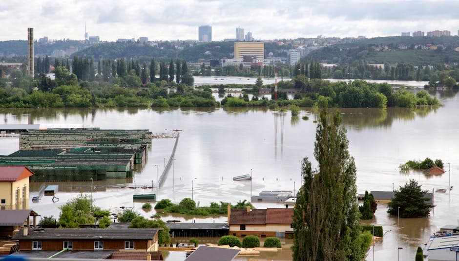 Aerial shot of a city affected by severe flooding with submerged buildings and roads.