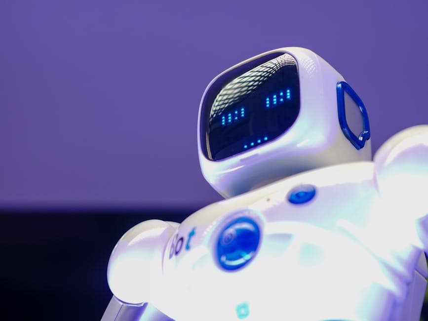 A modern humanoid robot with digital face and luminescent screen, symbolizing innovation in technology.