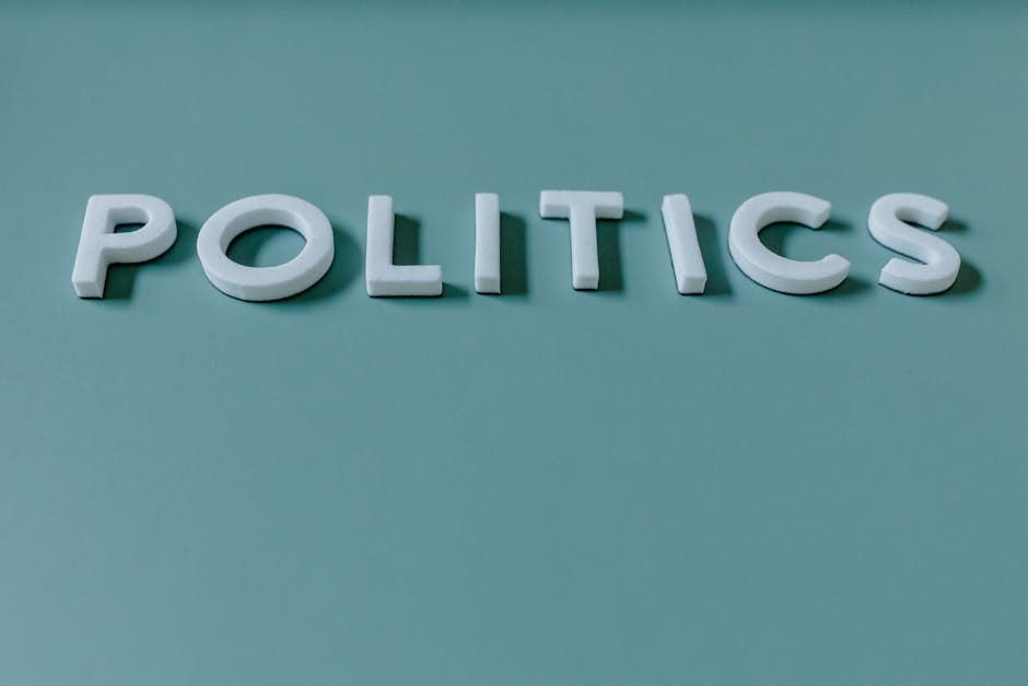 Close-up image of the word 'Politics' against a teal green background, highlighting political themes.
