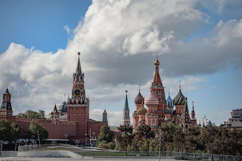 Stunning view of the Kremlin and Saint Basil's Cathedral in Moscow, Russia under a partly cloudy sky.