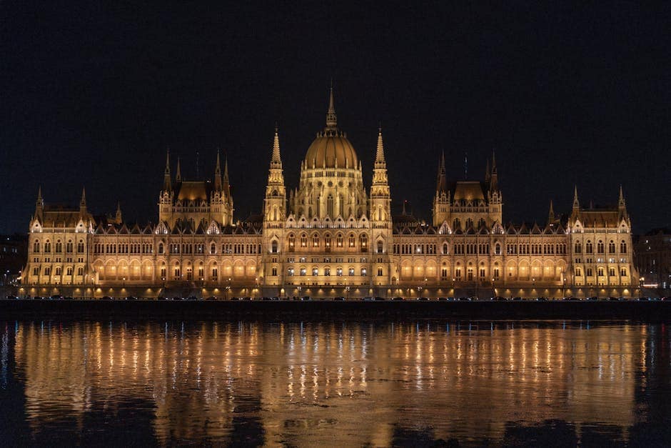 Captivating night view of the illuminated Hungarian Parliament Building reflecting in the Danube River.