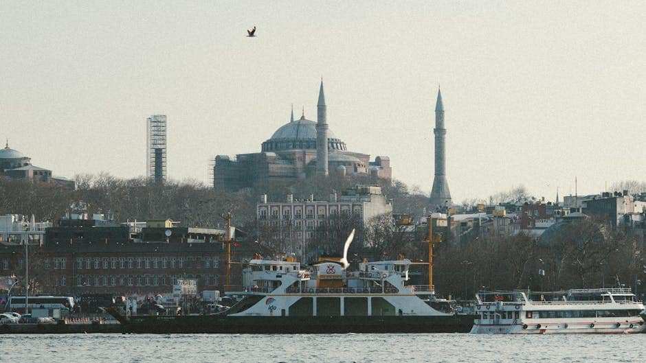 A picturesque view of the Hagia Sophia and boats on the Bosphorus in Istanbul.