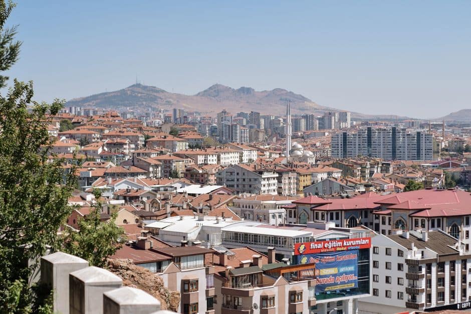 Discover Ankara's vibrant cityscape with diverse residential architecture and hill backdrop.