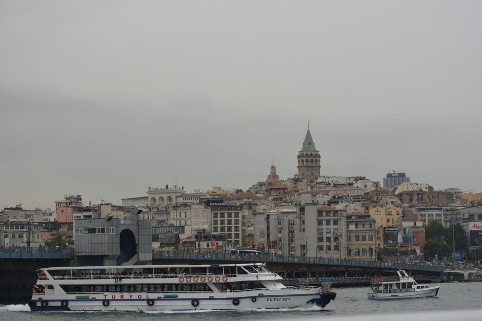 Ferry traversing the Bosphorus near Istanbul's iconic Galata Tower.