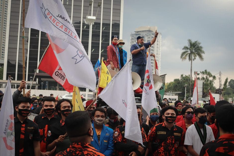 Crowd of activists protesting with banners in Jakarta, Indonesia.