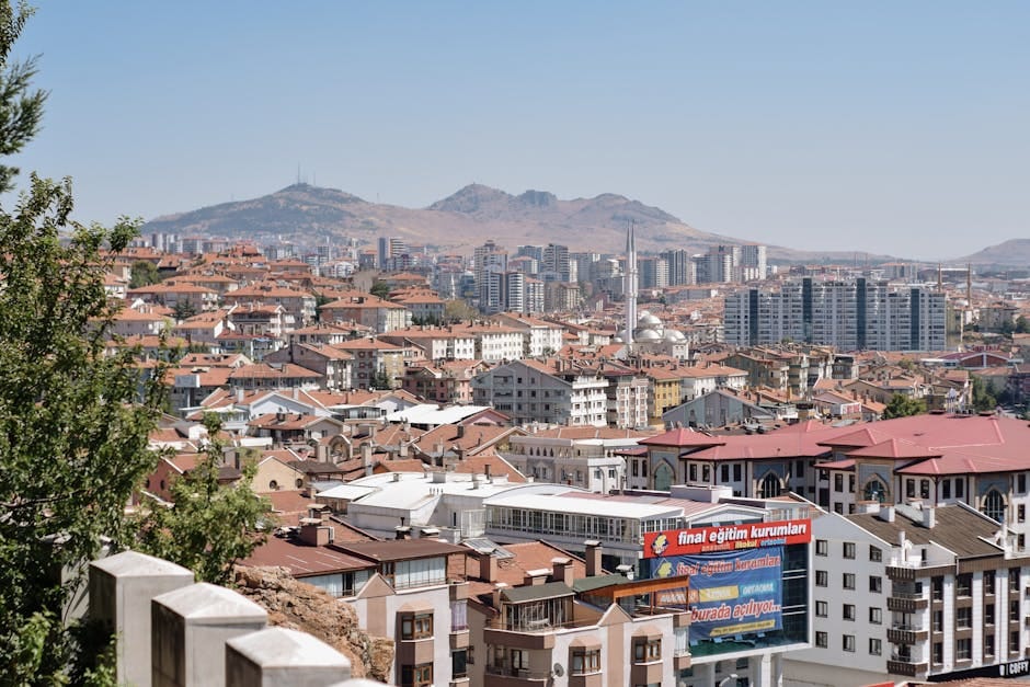 Discover Ankara's vibrant cityscape with diverse residential architecture and hill backdrop.