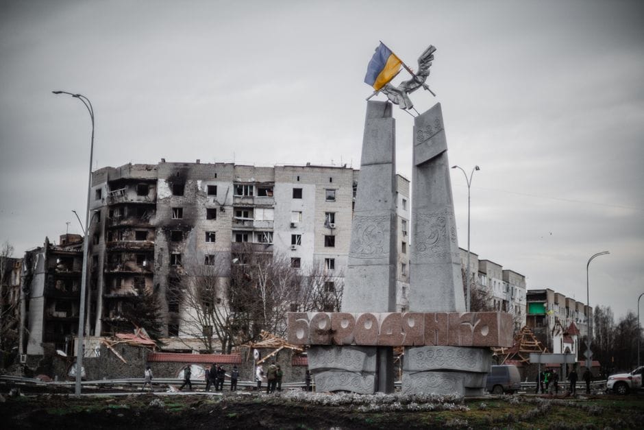 A monument stands beside war-torn buildings in Borodyanka, Ukraine.