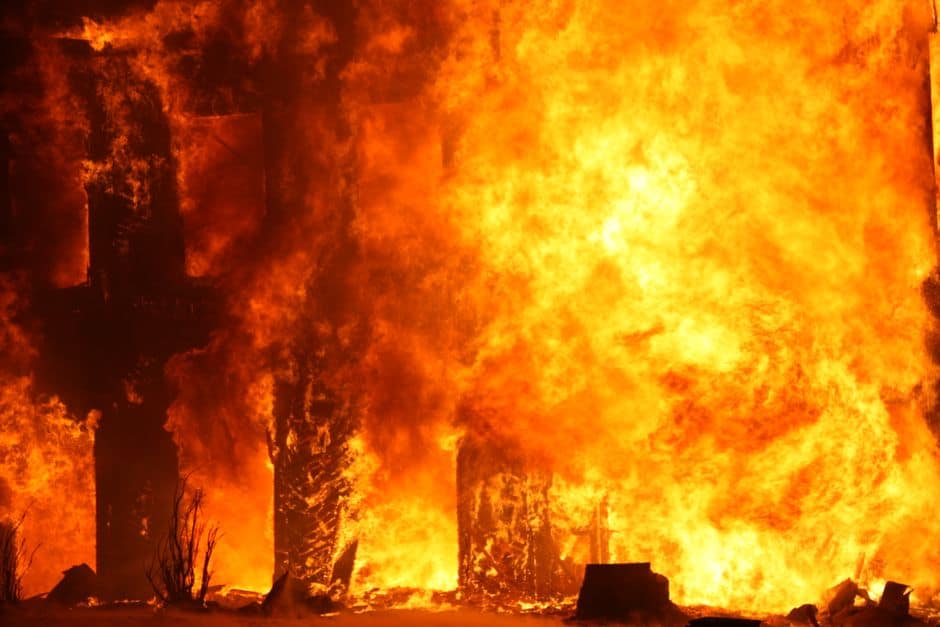 Dramatic image of a building consumed by fire, showcasing intense flames and smoke.