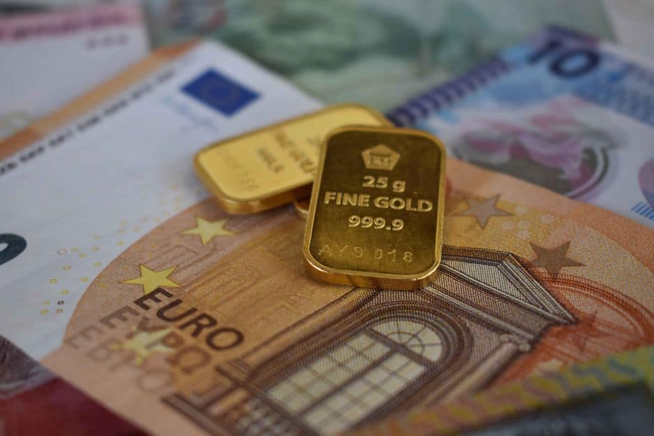 Gold bars placed on Euro banknotes representing wealth and finance concepts.