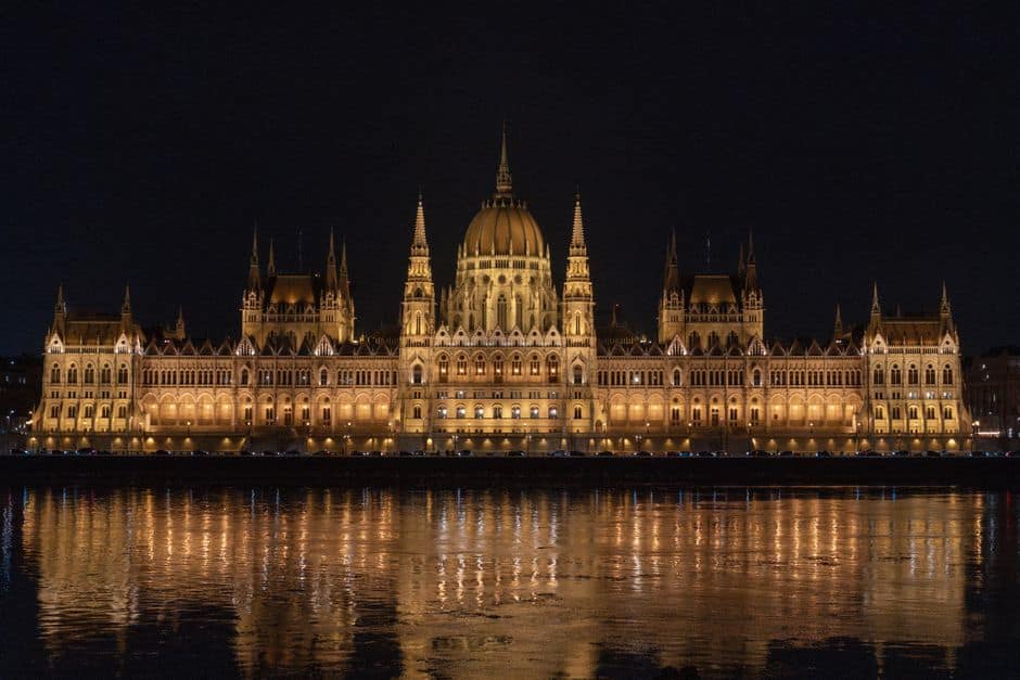 Captivating night view of the illuminated Hungarian Parliament Building reflecting in the Danube River.