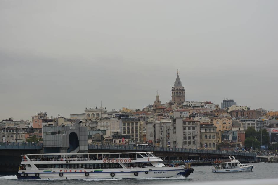 Ferry traversing the Bosphorus near Istanbul's iconic Galata Tower.