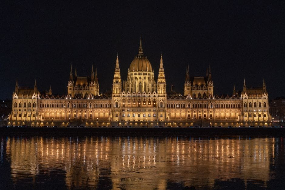 Captivating night view of the illuminated Hungarian Parliament Building reflecting in the Danube River.