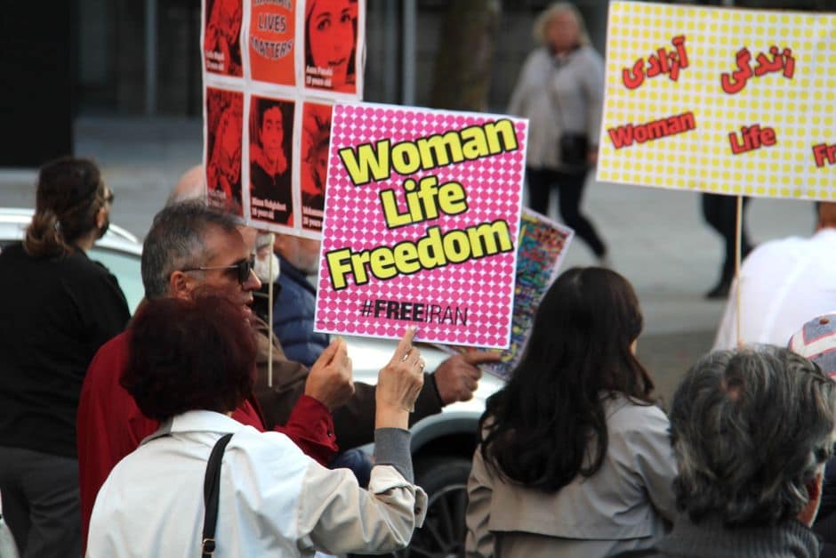A peaceful protest in Vancouver supporting women's rights with signs for freedom and justice.