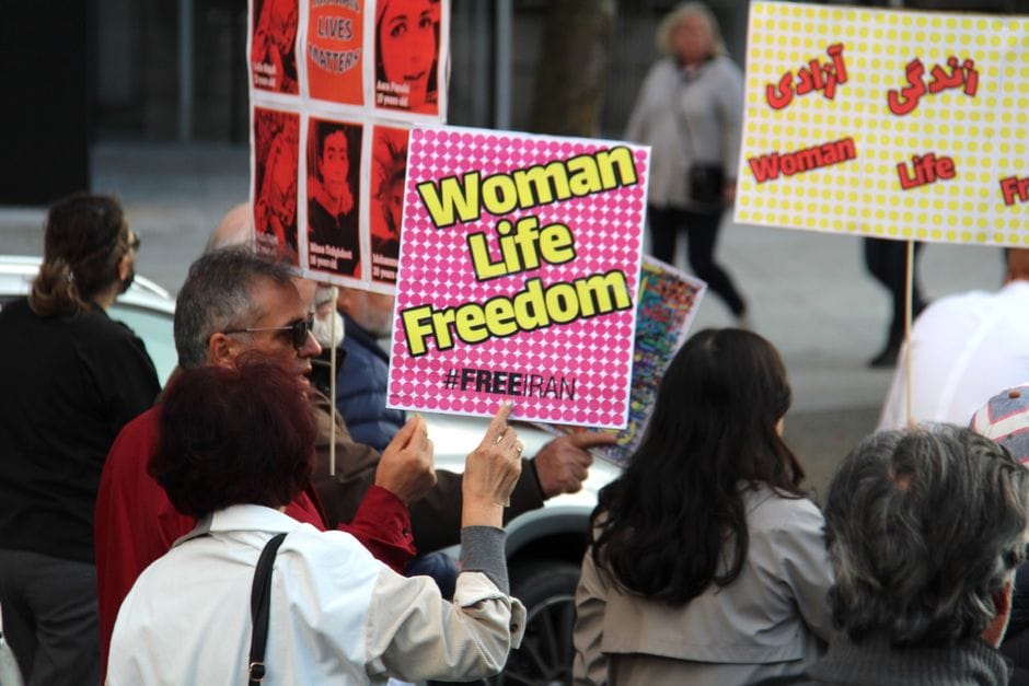 A peaceful protest in Vancouver supporting women's rights with signs for freedom and justice.
