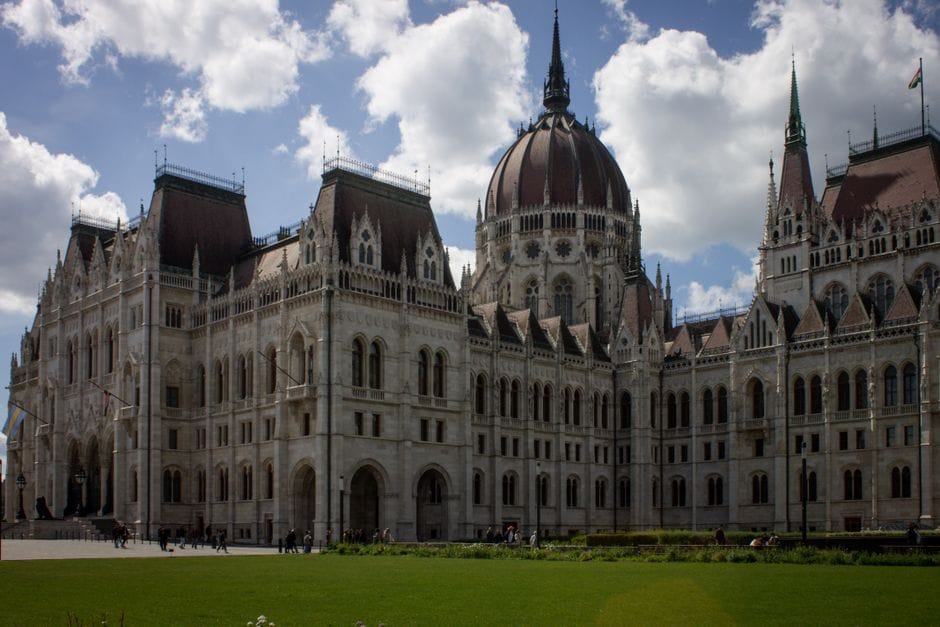 The iconic Hungarian Parliament Building in Budapest under a clear blue sky.