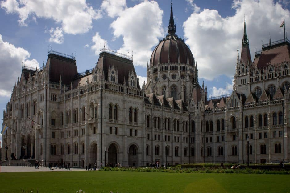 The iconic Hungarian Parliament Building in Budapest under a clear blue sky.