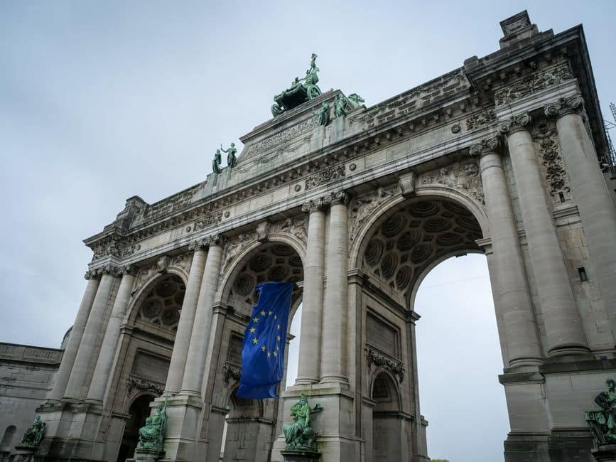 View of the Triumphal Arch in Brussels adorned with European Union flag.
