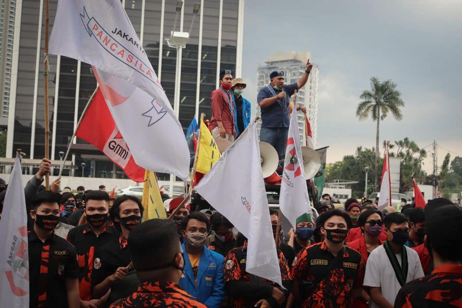 Crowd of activists protesting with banners in Jakarta, Indonesia.